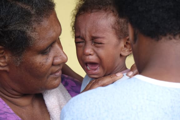 A child in vaccinated for measles in Vanuatu after Cyclone Pam.