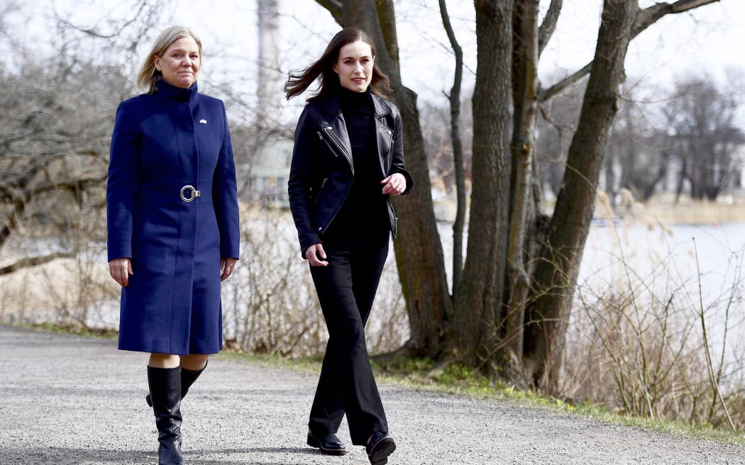Swedish Prime Minister Magdalena Andersson (L) and Finnish Prime Minister Sanna Marin walk prior to a meeting on whether to seek NATO membership in Stockholm, Sweden, on April 13, 2022. - Rattled by Russia's invasion of Ukraine, Finland will kickstart a debate that could lead to seeking NATO membership, a move that would infuriate Moscow. (Photo by Paul WENNERHOLM / TT News Agency / AFP) / Sweden OUT