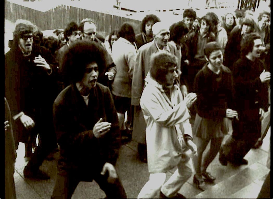 The haka Ka Mate performed at parliament 1972 by Te Reo Māori Society members, John pictured far left, prominent kaumatua Te Oenuku Rene picture in the middle of group.