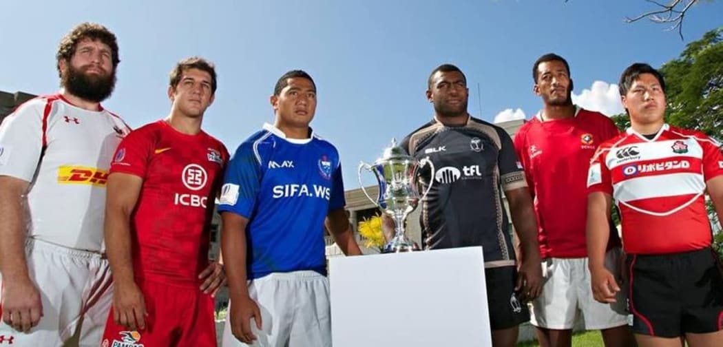 The captains of Canada A, Argentina Pampas XV, Samoa A, Fiji Warriors, Tonga A and Junior Japan pose with the Pacific Challenge Trophy.
