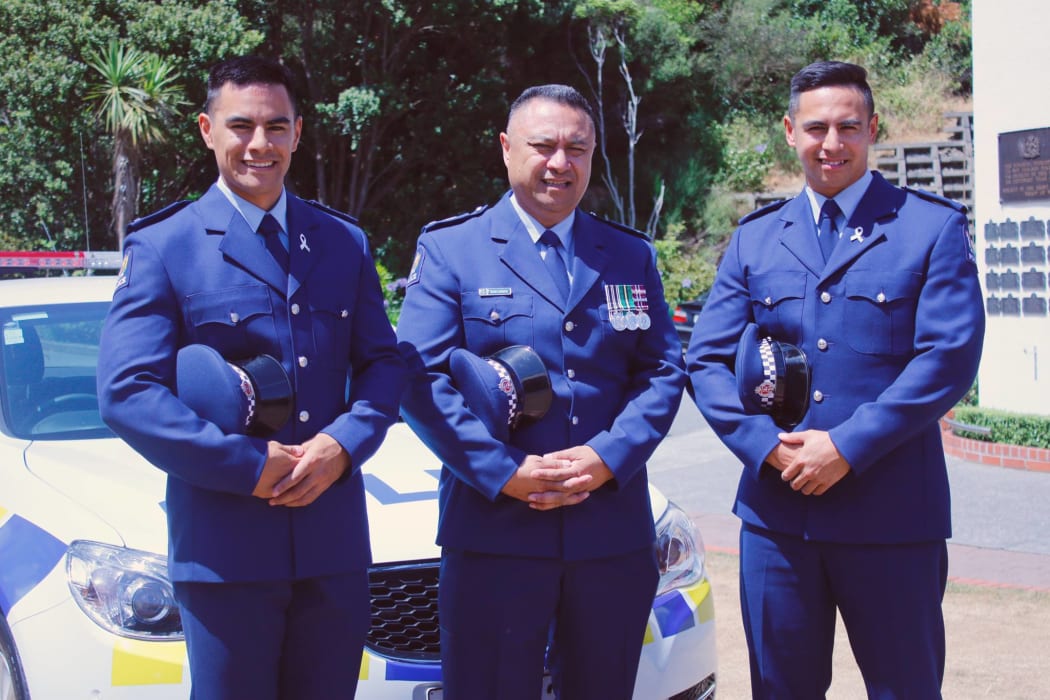 Officers Dave Laumatia with his sons Allan and Charlie beside him