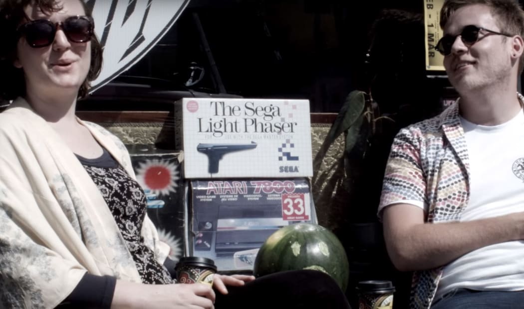 Two actors in the web series Burbs sit on a bench in the Wellington suburb of Newtown.