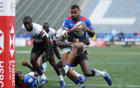 Samoa's David Afamasaga drives through the Kenya defence for a try during the ninth place quarter final clash.