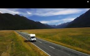 A camper van is seen driving on the wrong side of the road in a Tourism New Zealand video.