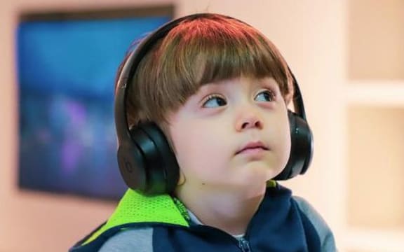 small boy with headphones on