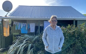 Robyn Cann outside her cabin at Lake Ferry Holiday Park in South Wairarapa.