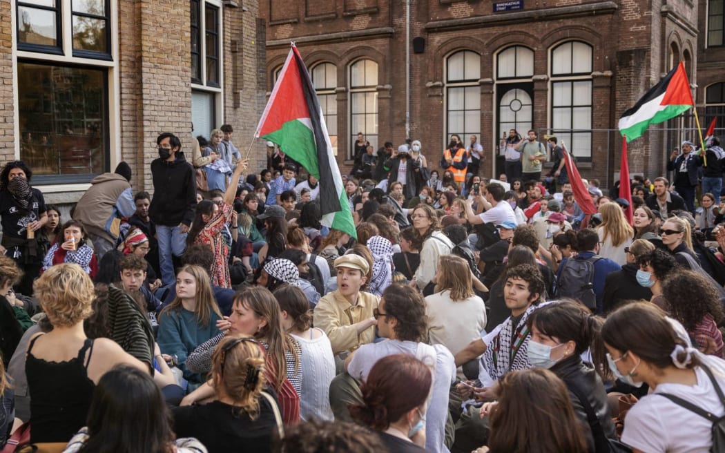 AMSTERDAM - Demonstrators stand in front of the door of the Binnengasthuis of the University of Amsterdam (UvA) during a protest in solidarity with pro-Palestinian students.