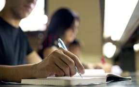 A file photo shows university students studying for an exam