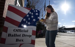 A voter drops of her ballot at the Granby Town Hall  in Granby, Colorado on November 3, 2020.