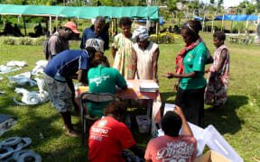 Rebuild kits being distributed on Tanna in Vanuatu by Care International.