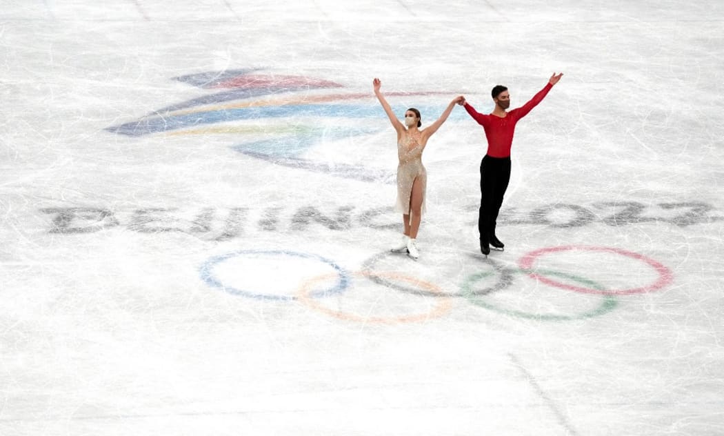 Gold medalists France's Gabriella Papadakis and Guillaume Cizeron pose during the flower ceremony for the ice dance figure skating event during the Beijing 2022 Winter Olympic Games at Capital Indoor Stadium in Beijing, China