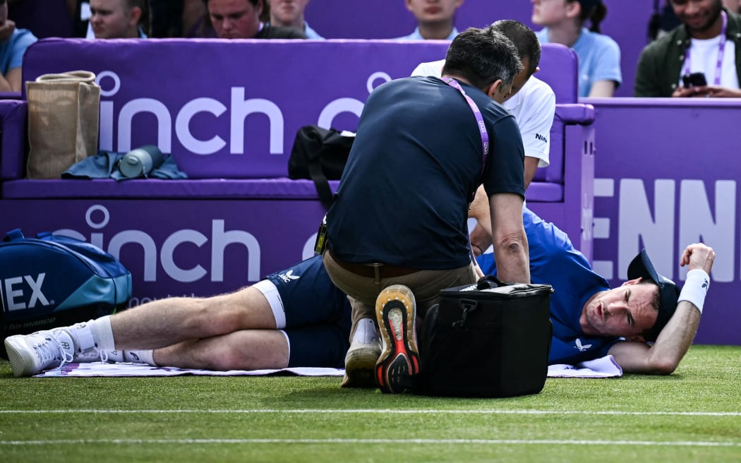 Britain's Andy Murray receives medical treatment during his men's singles round of 16 match against Australia's Jordan Thompson at the Queen's Club tournament, 2024.