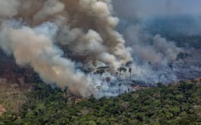 Smoke billowing from forest fires in Candeias do Jamari, close to Porto Velho in Rondonia State, in the Amazon basin in northwestern Brazil, on 24 August, 2019.