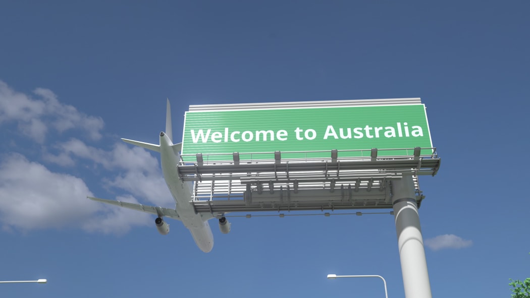 Airplane flies over highway sign