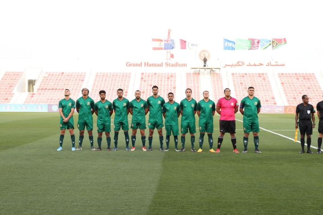The Cook Islands stand for the national anthem prior to their match against Solomon Islands.
