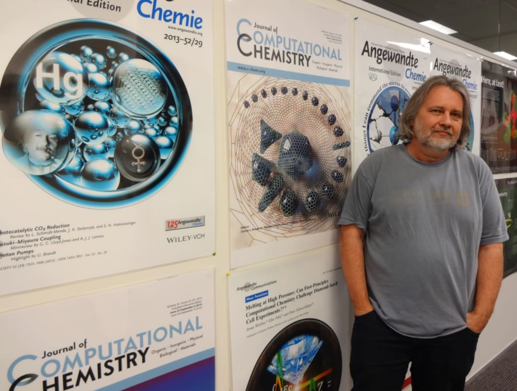 Massey University theoretical chemist Peter Schwerdtfeger was awarded the Rutherford Medal, New Zealand's highest science prize, for his research on how atoms and molecules interact at the quantum level. In the background are the journal covers that feature his work.