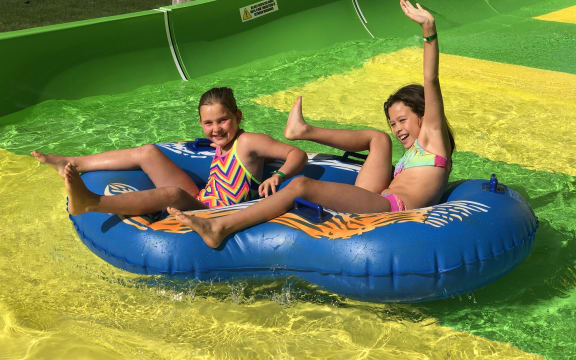 Tahlia Bresson, 8 and Tenesha Hey, 9, enjoy the Conical Thrill waterslide at Hanmer Springs on its opening day.