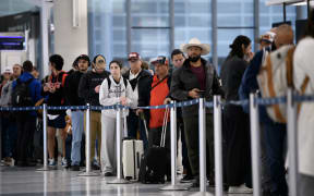 People wait in a security checkpoint line at George Bush Intercontinental Airport in Houston, Texas, on 4 November, 2025.