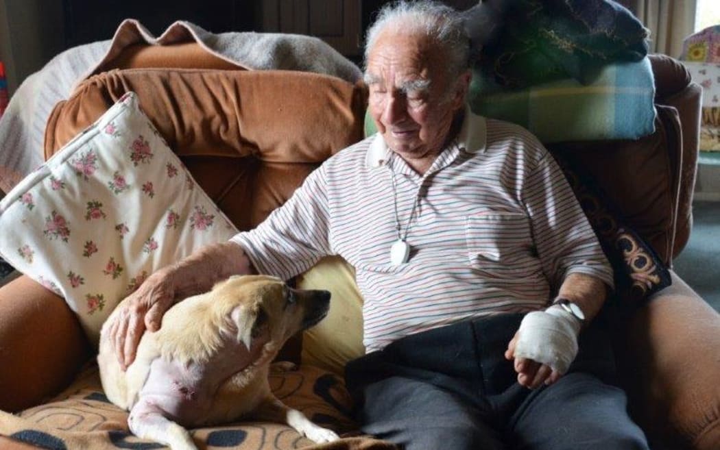 Jim Morgan comforts his dog Sandy, which was attacked on the weekend.