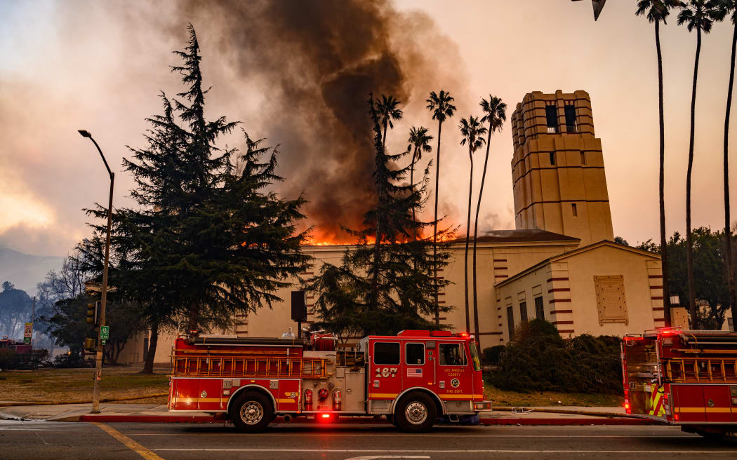 Firefighters arrive at the scene as Eliot Arts Magnet Middle School burns during the Eaton fire in the Altadena area of Los Angeles county, California, on January 8, 2025. - At least five people are now known to have died in wildfires raging around Los Angeles, with more deaths feared, law enforcement said January 8, as terrifying blazes leveled whole streets, torching cars and houses in minutes.
More than 1,000 buildings have burned in multiple wildfires that have erupted around America's second biggest city, forcing tens of thousands of people from their homes. (Photo by JOSH EDELSON / AFP)