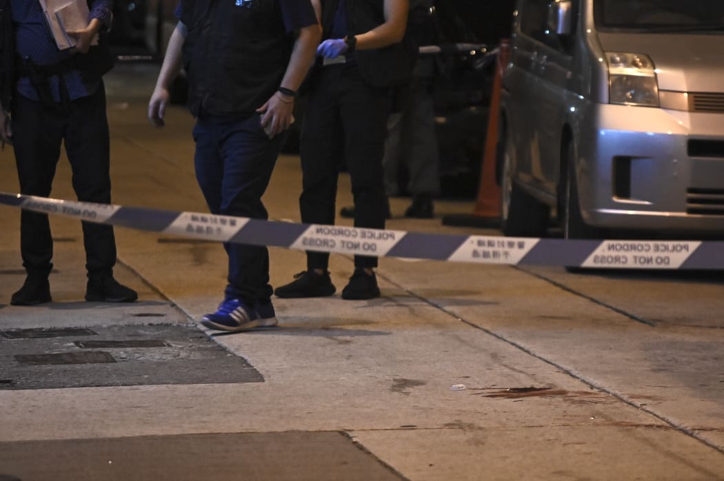 Blood is seen beyond a police cordon, where Jimmy Sham, convener of the Civil Human Rights Front (CHRF), was assaulted by four to five people wielding hammers.