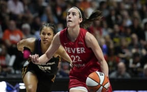 UNCASVILLE, CONNECTICUT - SEPTEMBER 25: Caitlin Clark #22 of the Indiana Fever drives against Veronica Burton #22 of the Connecticut Sun during the third quarter of Game Two of the 2024 WNBA Playoffs first round at Mohegan Sun Arena on September 25, 2024 in Uncasville, Connecticut.   Joe Buglewicz/Getty Images/AFP (Photo by Joe Buglewicz / GETTY IMAGES NORTH AMERICA / Getty Images via AFP)