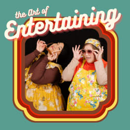 Two women in vintage 70s clothing pose, framed by a vintage feeling frame and the words “The Art of Entertaining”.