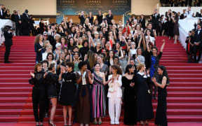 Directors, actresses and industry representatives pose on the red carpet in protest of the lack of female filmmakers honored throughout the history of the festival.