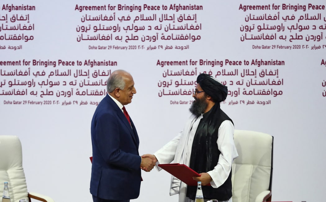 US representative Zalmay Khalilzad (left) and Taliban co-founder Mullah Abdul Ghani Baradar after signing a peace agreement between the US and Taliban, in Doha, 29 February, 2020.