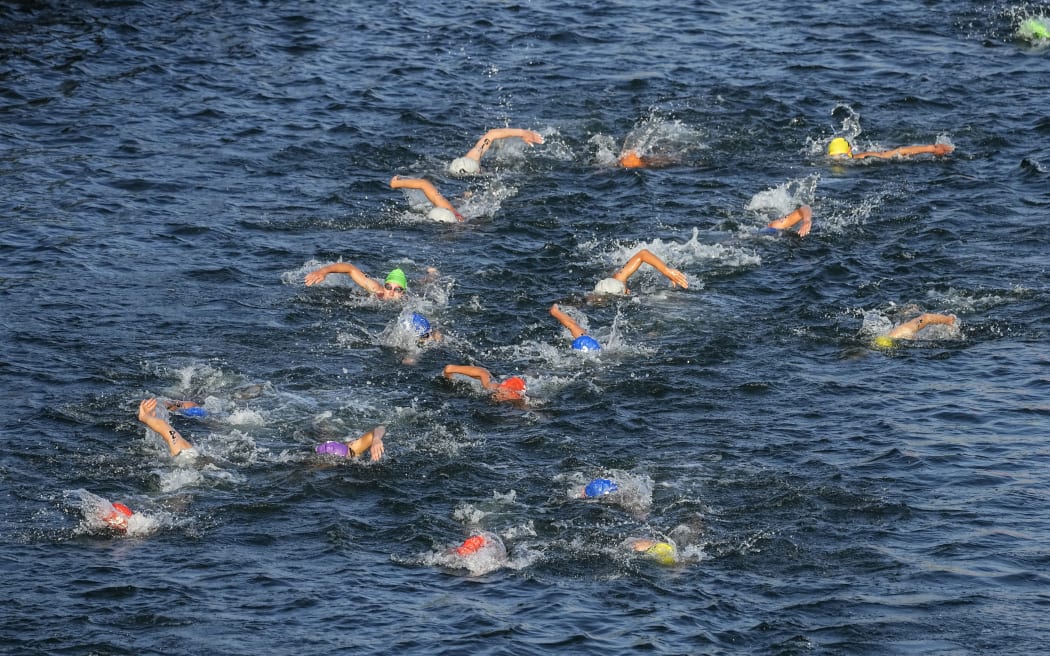 Athletes swim in the Seine River during the women's triathlon test event for the Olympics Games in Paris, 17 August, 2023.