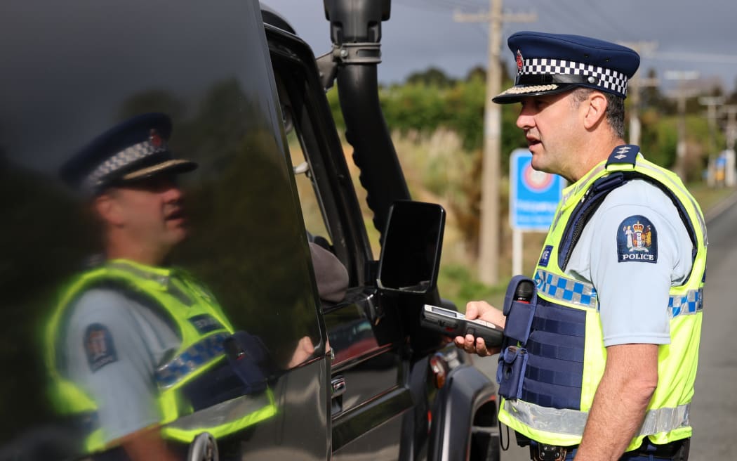 Northland road policing manager Inspector John Fagan checks a motorist’s breath-alcohol level.
