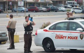 Police collect evidence the morning after the demonstration to mark the first anniversary of the shooting of Michael Brown in Ferguson, Missouri.