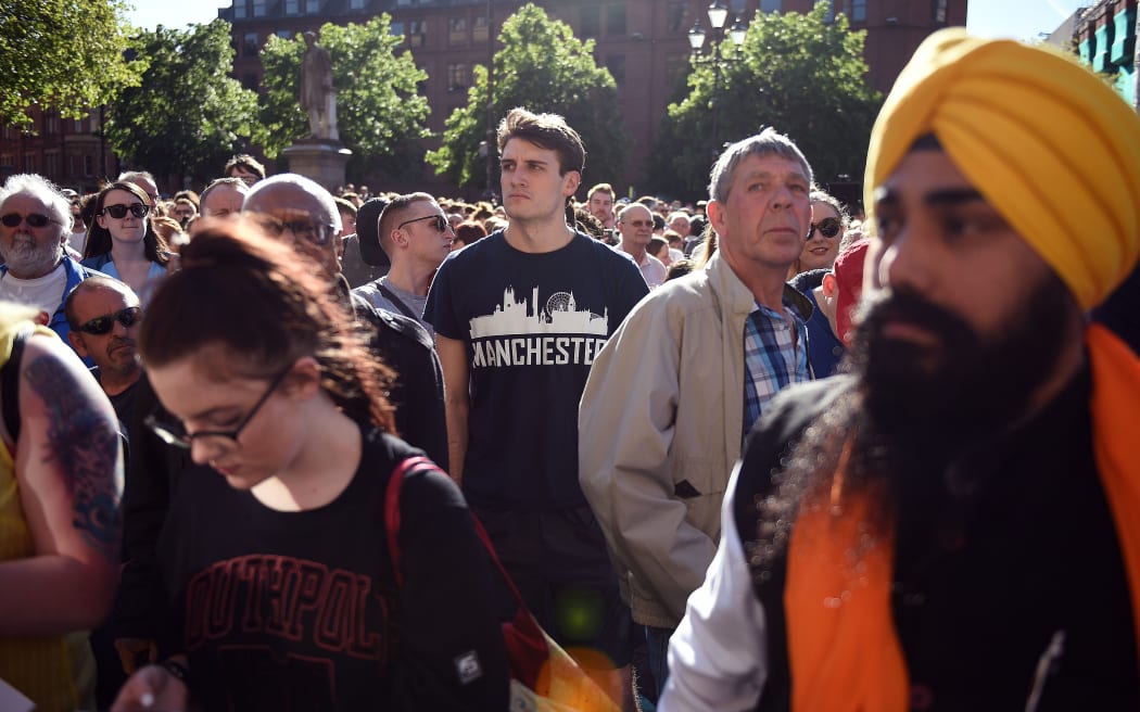 People congregate to attend a vigil in Albert Square in Manchester following the attack at Manchester Arena.