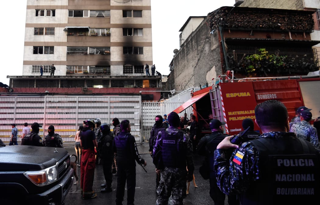 Security forces and members of the Bolivarian National Intelligence Service (Sebin) check a building after an explosion was heard near the place where Venezuelan President Nicolas Maduro was attending a ceremony to celebrate the 81st anniversary of the National Guard in Caracas
