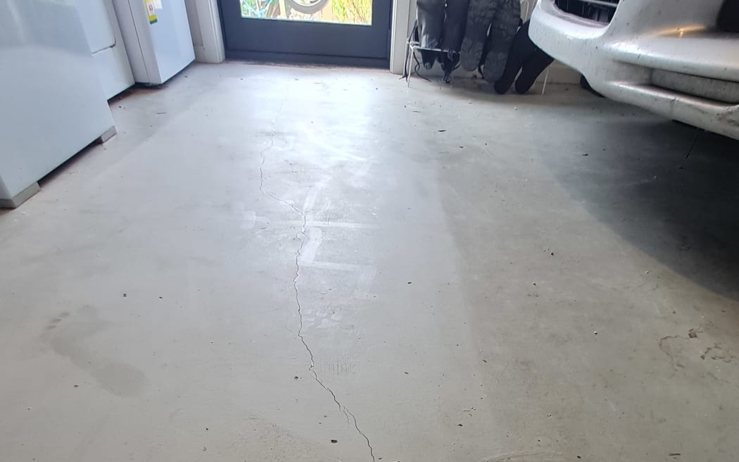 A crack in the garage floor caused by the quake.