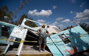 BONITA SPRINGS, FL - OCTOBER 01: John Vest looks at his storm damaged business, Capt. Johns Subtropic Charters, at Fish Trap Marina on October 1, 2022 in Bonita Springs, Florida. The category four storm made a U.S. landfall on Cayo Costa, Florida Wednesday afternoon.   Sean Rayford/Getty Images/AFP (Photo by Sean Rayford / GETTY IMAGES NORTH AMERICA / Getty Images via AFP)