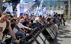 Protesters break police barricades during a demonstration against the Israeli government’s controversial justice reform bill in Tel Aviv on 1 March, 2023.