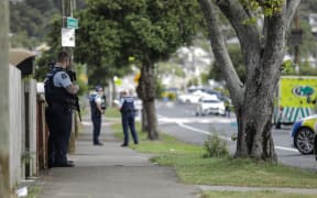 Multiple police cars and ambulances are on the street.