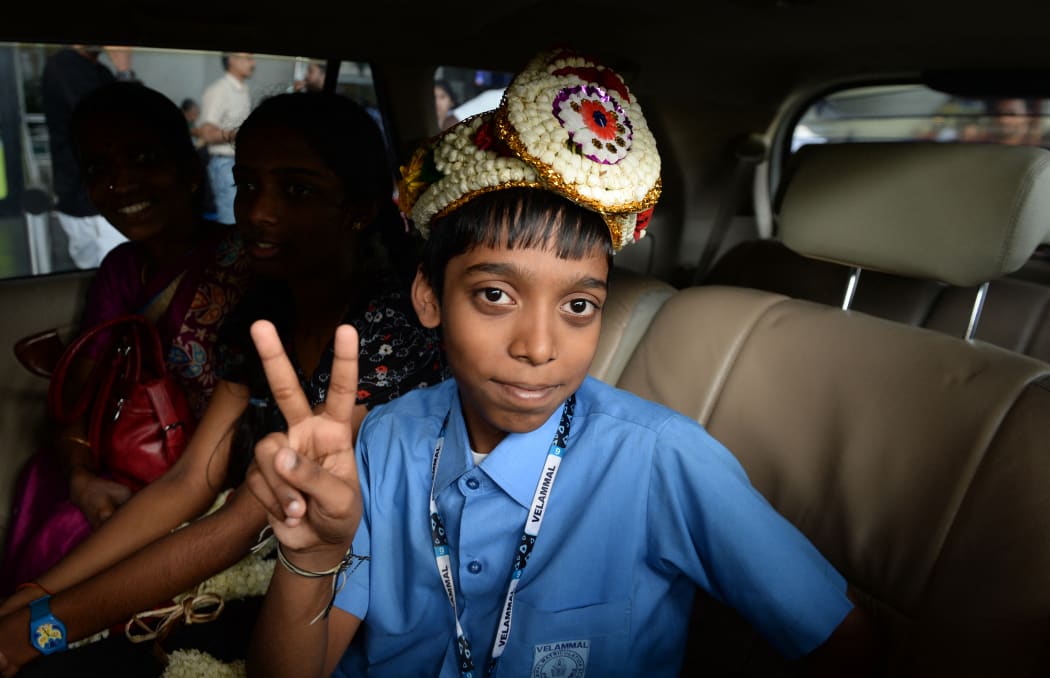 Indian chess prodigy Rameshbabu Praggnanandhaa, poses for a photograph on his arrival at an airport in Chennai after becoming the world's second youngest chess grandmaster ever in 2018.