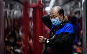 A man wears a face mask as he travels on the metro during a Lunar New Year holiday in Hong Kong on January 27, 2020.