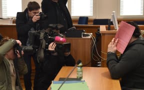 Niels H hid behind a folder during his trial last year.