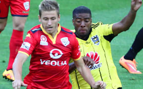 Phoenix' Roly Bonevacia battles for possession wih Adelaide United's Stefan Mauk.