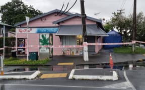 Police outside a dairy in the Auckland suburb of Sandringham where a man was fatally stabbed.