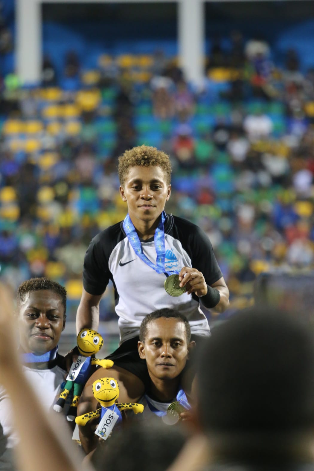 Fiji women's captain, Mereula Torooti, is carried aloft sporting her Pacific Games gold medal. Honiara 25 November 2023