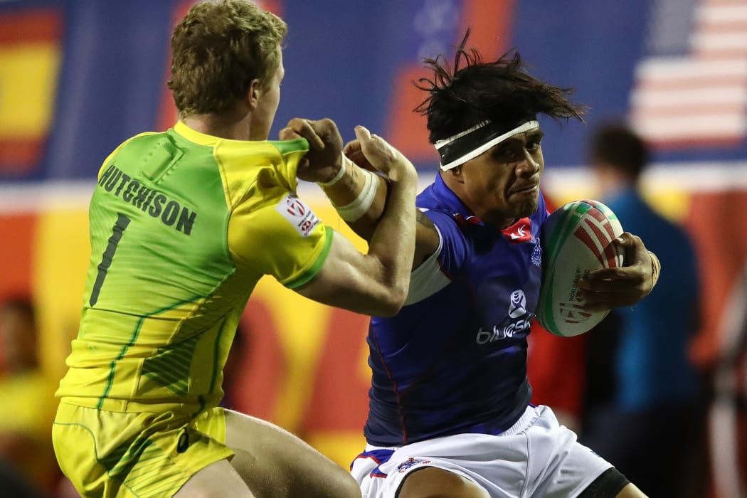Samoa's Tofatu Solia fends off the Australian defence.