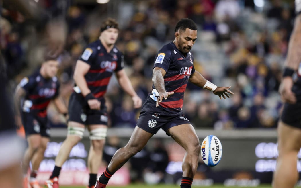 Crusaders Sevu Reece kicks a drop goal against the Brumbies.