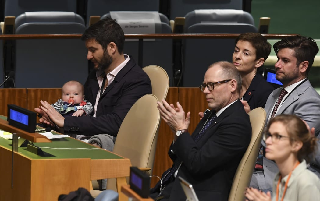Clarke Gayford holding daughter Neve Te Aroha Ardern Gayford, as his Prime Minister Jacinda Ardern speaks during the Nelson Mandela Peace Summit September 24, 2018.