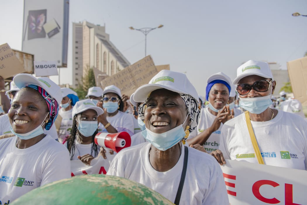 Women take part in a march for the environment in Dakar on October 23, 2021, one week before the COP26 global climate summit.