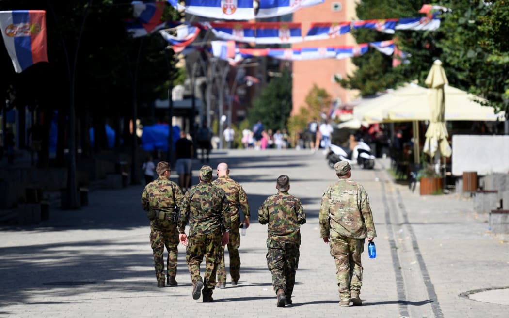 NATO-led international peacekeeping force the Kosovo Force (KFOR) soldiers walk in the northern part of the ethnically divided city of Mitrovica, on September 28, 2023. Unease in Kosovo's troubled north has been percolating for months, following Prime Minister Albin Kurti's decision in May to install ethnic Albanian mayors in four Serb-majority municipalities there -- despite an election boycott by the area's Serbs. Protests followed, as well as the arrest by Serbia of three Kosovar police officers, and a riot by Serb demonstrators that saw dozens of NATO peacekeepers injured. (Photo by STRINGER / AFP)