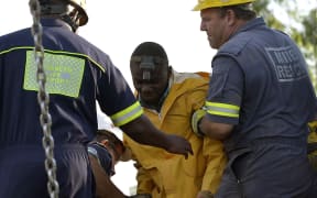 Rescuers bring one of the miners to the surface.